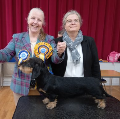 Betty with judge and rosette on table